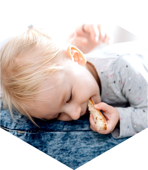 A child is eating a piece of bread.