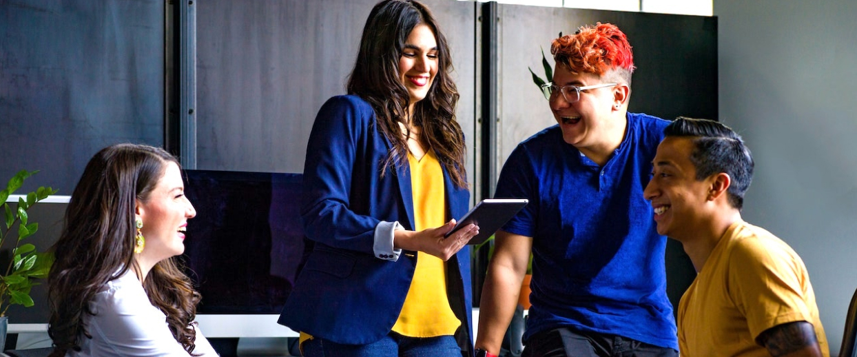 A group of people laughing in an office.