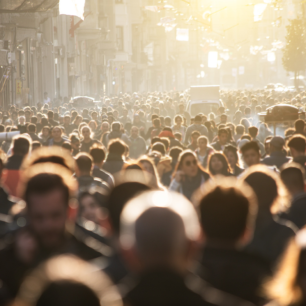 A crowd of people walking down a street.