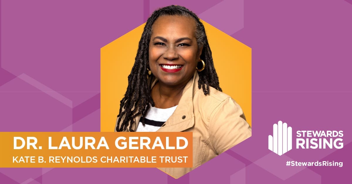 Dr. Laura Gerald smiling, with text reading "Dr. Laura Gerald, Kate B. Reynolds Charitable Trust" and the "Stewards Rising" logo and hashtag "#StewardsRising" on a purple background.